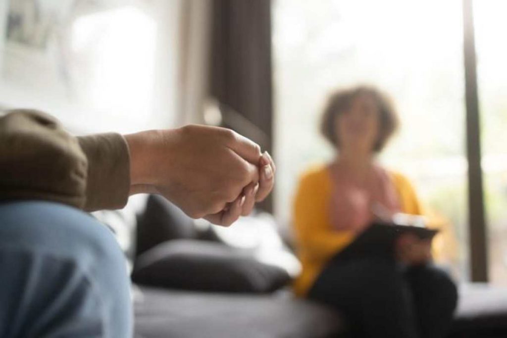Caring therapist supporting client in Oakland trauma therapy session.