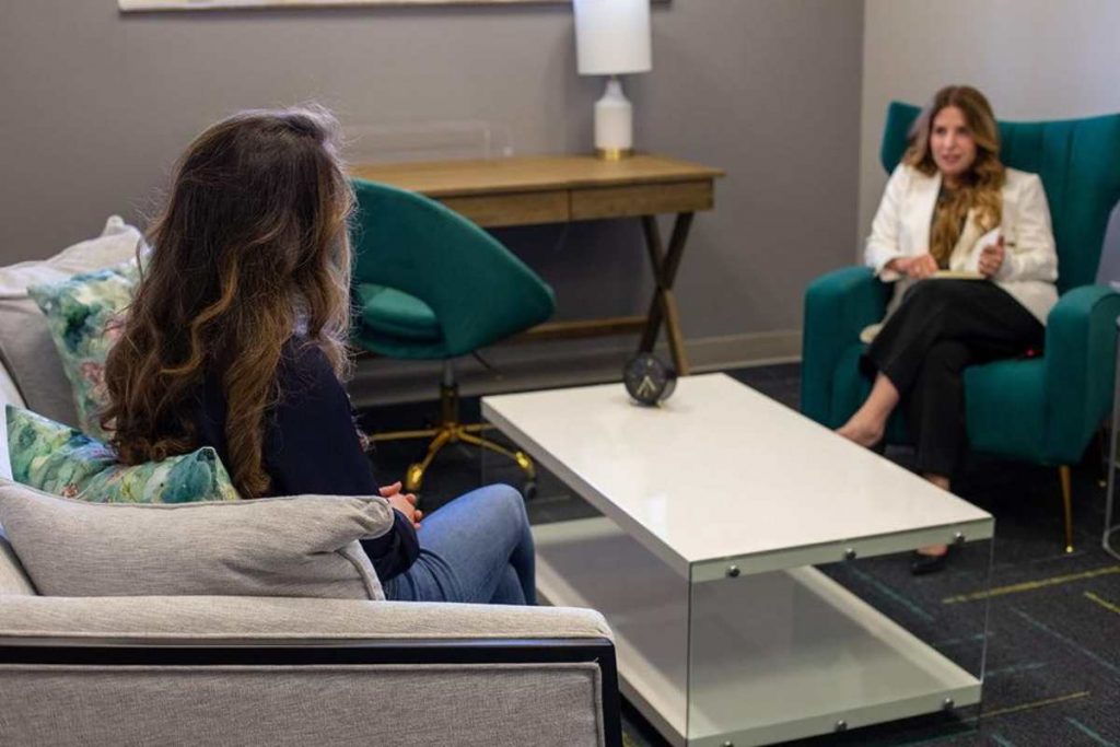 Therapist guiding client through integrative trauma therapy session.