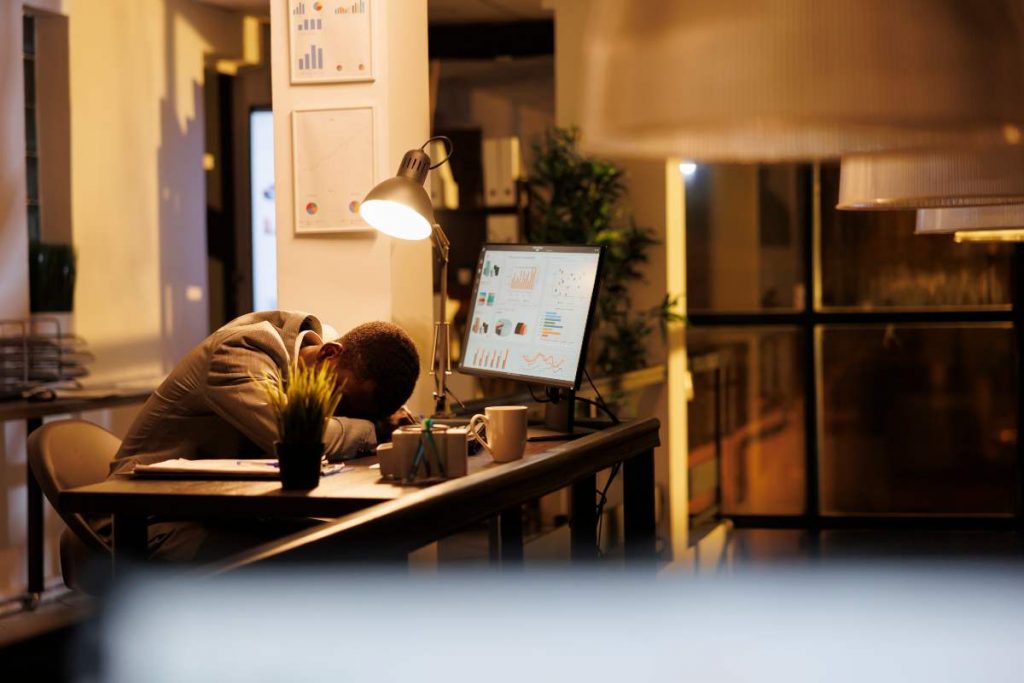 Person overwhelmed by screen fatigue at work